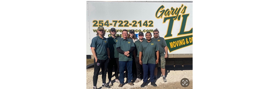 Gary's TL moving and delivery team standing in front of branded truck